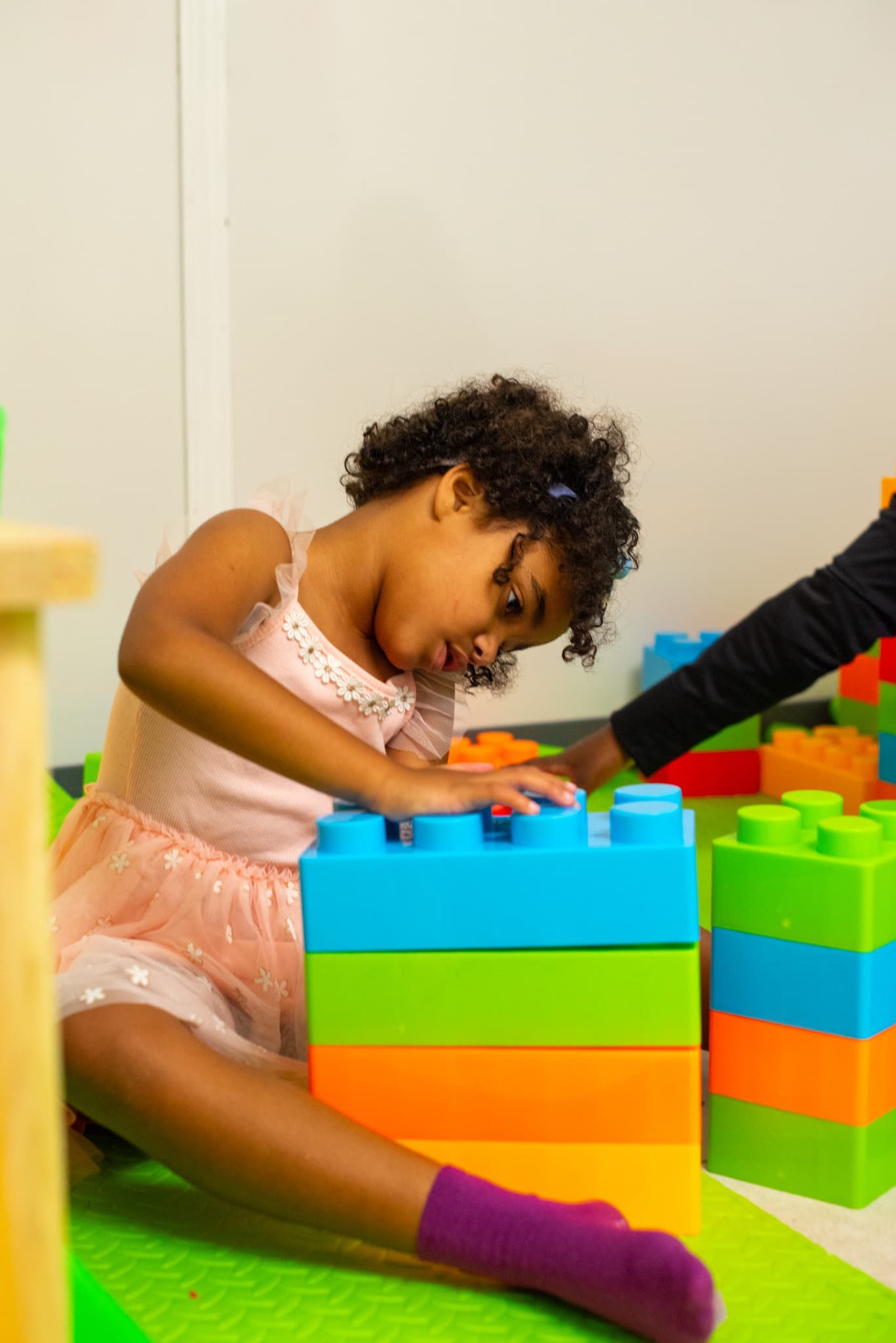 Child participating in play and movement with large building blocks